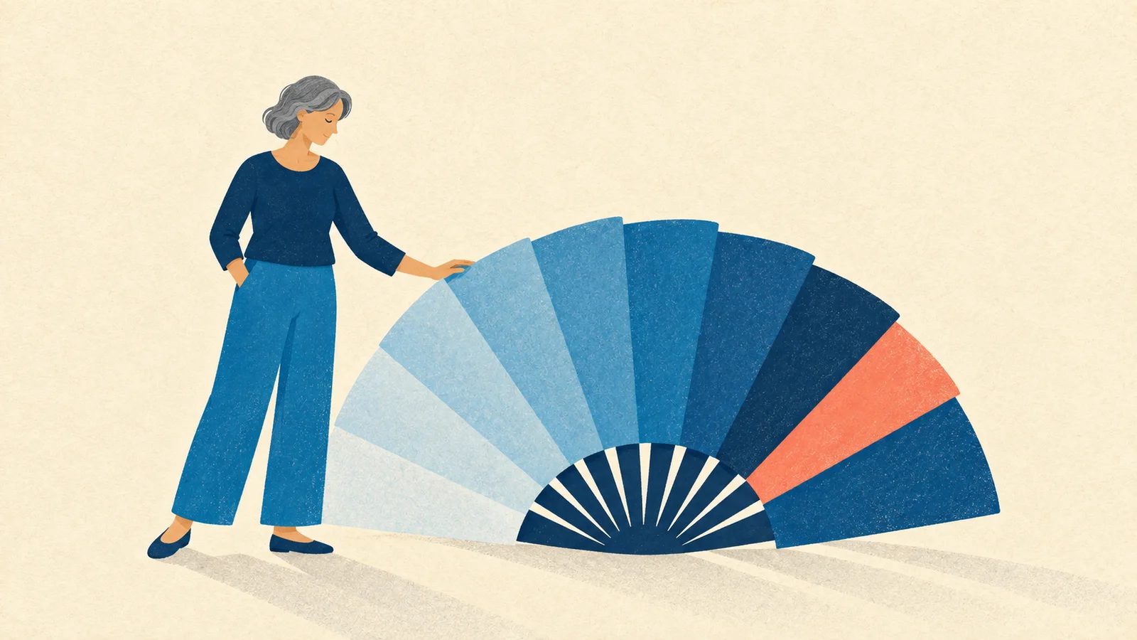 Mulher de cabelos grisalhos acompanha a abertura de um grande leque azul com uma faixa coral, simbolizando uma fase de mudança.